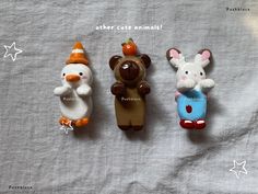 three small toy animals sitting next to each other on a bed with the words, mother cute animals