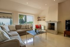 a living room filled with furniture and a fire place