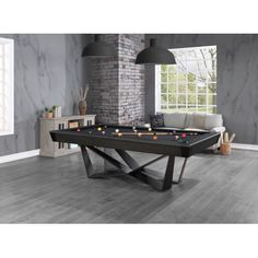 a pool table in the middle of a living room with grey walls and wood flooring