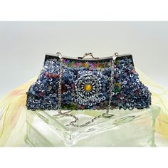 Beautiful beaded and sequined evening bag with a jeweled motif center on both sides. Silver clasps that work like a charm. Silver grey lining free of stains. Measures 9" wide, 4 1/2" tall without chain/10" with chain, 2" deep. Multicolor Sequined Evening Bag, Multicolor Sequined Evening Clutch, Embellished Multicolor Evening Bag, Multicolor Hand-embellished Clutch For Party, Multicolor Hand Embellished Clutch For Party, Blue Beaded Evening Bag For Party, Rectangular Embellished Evening Bag, Evening Multicolor Sequins Bag, Silver Hand-embellished Bag For Events