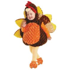 a small child dressed in a turkey costume