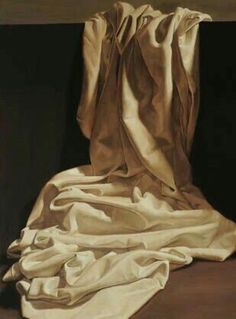 an image of a painting with white cloth on the ground and one piece of fabric draped over it