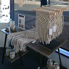 a table with some items on it in front of a glass window and another item that is hanging from the ceiling