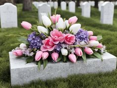 a bunch of flowers that are sitting on a grave