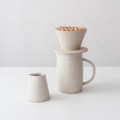 three ceramic cups stacked on top of each other