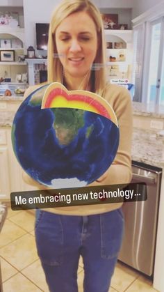 a woman is holding up a plate with the earth on it in her hands that says me embracing technology