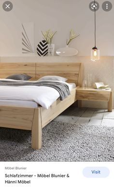 a bed room with a neatly made bed next to a night stand and nightstands