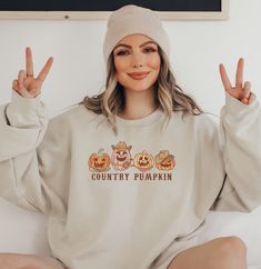 Embrace the rustic charm of autumn with our "Country Pumpkins" sweatshirt. This cozy and stylish sweater features a delightful row of four western pumpkins, capturing the essence of a serene countryside pumpkin patch. Crafted with care, this sweatshirt brings together comfort and seasonal aesthetics, making it a perfect addition to your fall wardrobe. Made from premium quality materials, our sweatshirt ensures warmth and durability, while its unique design adds a touch of autumnal magic to any o Pumpkin Patch Design, Fall Pumpkin Patch, Autumn Sweater, Stylish Sweater, Pumpkin Sweatshirts, Gift For Nurse, Stylish Sweaters, Cozy Autumn, Autumn Cozy