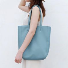 Light Blue Vertical Soft Leather Tote Bag for Women Light Blue Casual Shoulder Bag For Shopping, Casual Light Blue Shoulder Bag For Shopping, Light Blue Tote Shoulder Bag For Spring, Light Blue Shopping Bag For Spring, Light Blue Shopping Bags For Spring, Light Blue Spring Shopping Bag, Light Blue Shoulder Bag For Summer Travel, Summer Travel Light Blue Shoulder Bag, Light Blue Rectangular Shoulder Bag For Summer