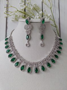 The perfect hand crafted jewelry is sure to compliment your bridal and party outfit this season!  A GORGEOUS fushion of elegance and style - this unique set designed with Emerald green stones and american diamond details is sure to be ADORED for years to come. Full set comes with earrings and is finished with a silver base. **ON TREND AND CHIC ** Adorn yourself in this LIGHT WEIGHT and easy to wear design - pairs well with modern looks! Lovely BRIDAL set for your big day and Pre-Events (Sangeet, Teardrop Jewelry With Intricate Design For Wedding, Teardrop Wedding Jewelry With Intricate Design, Teardrop Jewelry With Intricate Design For Party, Teardrop Party Jewelry With Intricate Design, Cubic Zirconia Wedding Jewelry For Diwali, Festive Cubic Zirconia Bridal Necklace Gift, Festive Teardrop Cubic Zirconia Jewelry, Elegant Teardrop Kundan Necklace For Wedding, Traditional Teardrop Bridal Necklace For Celebration