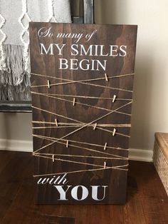 a wooden sign that says, in many ways my smiles begin with you on it