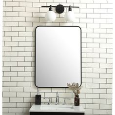 a bathroom vanity with a large mirror above it