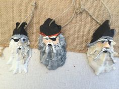 three gnomes with hats and beards are hanging on the wall next to each other