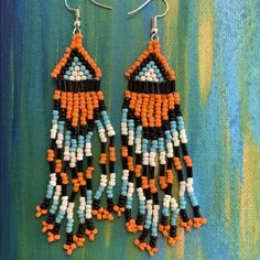 Boho Beaded Tribal Earrings With Orange, White, Turquoise, & Black Beads One Size About 4” Long New With Tag Orange Dangle Jewelry With Black Beads, Orange Dangle Beaded Earrings With Black Beads, Orange And Black Beads Dangle Earrings, Orange Beaded Earrings With Black Beads, Orange Adjustable Beaded Earrings For Festival, Adjustable Orange Beaded Earrings For Festival, Bohemian Turquoise Beaded Earrings With Black Beads, Blue Bohemian Beaded Earrings With Black Beads, Bohemian Orange Beaded Earrings With Black Beads