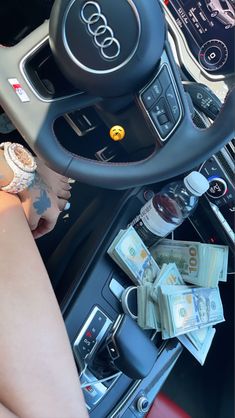 the interior of an audi car with money in the center console