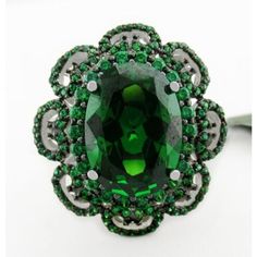 Karat : .925 Sterling Silver Gemstones : 1 Lab Created Emerald - 7.85 Carats Emerald Grades, Hue . . . Green Tone . . . Medium Dark Saturation . . . Excellent No Inclusions Or Flaws 124 Genuine Peridots - 0.01 Ct Each Total Ct Weight : 1.24 Carats Peridot Grades, Hue . . . Green Olive Tone . . . Medium Saturation . . . Strong No Inclusions Or Flaws Shape Of Stone : Oval & Round Setting : Prong Size : 8.25 Net Weight : 7.4 Grams Dimensions : 14 Mm X 10 Mm - Main Gemstone Measurements Vintage Green Jewelry With Halo Setting, Luxury Green Collectible Jewelry, Collectible Green Emerald Ring With Center Stone, Green Sterling Silver Gemstones For Formal Occasions, Luxury Green Emerald Ring With Stone Setting, Collectible Hallmarked Green Jewelry, Hallmarked Green Gemstones, Classic Green Jewelry With Stone Setting, Formal Green Emerald Ring With Stone Setting