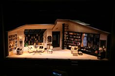 an open room with furniture and bookshelves on the walls in front of it