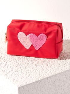 Store your odds and ends with Shiraleah’s Cara Heart Cosmetic Pouch. This pouch features an image of double hearts in sherpa adding texture and a fun detail to this essential pouch. Measuring L 7" × W 3" × H 4", and made from nylon, the Cara Hearts Cosmetic Pouch is perfect for holding your makeup, toiletries, etc. either in a vanity drawer at home, or in another bag on the go. Pair with other items from Shiraleah colletion to complete your look! Color: Red L 7" X W 3" X H 4" Nylon Gold Hardware Heart Makeup Pouch, Vanity Pouch, Vanity Drawer, Essential Pouch, Vanity Bag, Accessories Display, Odds And Ends, Women Cosmetics, Waterproof Bags