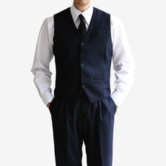 Introducing the Classic Fit Men's Basic Wool Blend Suit Vest in Navy Color. This dress suit waistcoat is a stylish addition to elevate any gentleman's formal attire. Designed with a classic fit, this vest offers a timeless and sophisticated silhouette. The navy color adds a touch of refinement, making it suitable for a variety of formal occasions and events. The 5-button design of this waistcoat adds a polished and traditional touch. It features a clean and minimalistic design, allowing it to effortlessly complement any dress shirt and suit combination. Whether you're attending a wedding, a business meeting, or any formal event, the Classic Fit Men's Basic Wool Blend Suit Vest in Navy Color is the perfect choice to complete your formal ensemble. It exudes sophistication and adds a refined Sleeveless Suits With Buttons For Work, Professional Single Breasted Three-piece Suit For Semi-formal Occasions, Elegant Single Breasted Button-up Vest, Elegant Single-breasted Button-up Vest, Semi-formal Three-piece Suit With Notch Lapel And Button Closure, Elegant Tailored Button-up Vest, Three-piece Suit With Button Closure For Work, Tailored Button-up Vest For Workwear, Navy Suits With Buttons For Work