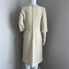 Vintage Adrian TabinUS Vintage Women's Size 16 (This is not a modern day size 16, please see the measurements below, it is smaller than modern 16)The detail work on this vintage mohair and wool dress is gorgeous. The overlay is made of a light yellow/ivory fine crochet texture with boucle detail at the collar and wrist. It has an ivory colored Talon brand zipper down the back. It is lined with an ivory acetate fabric. The sleeves are not quite 3/4 length. There is a belt loop on one side but it is missing on the other. I have left it as it was so you can decide what to do with it. This is a fairly conservative style with the crewneck line. I could see someone wearing this with a pillbox hat and some gloves. It is in very good vintage condition. Please see pictures for details and material Cream Lined Formal Dress, Cream Formal Lined Dress, Elegant Beige Vintage Dress For Daywear, Formal Cream Lined Dress, Classic Cream Dress For Vintage Events, Spring Vintage Cream Dress For Formal Occasions, Cream Vintage Dress For Spring Formal, Cream Vintage Dress For Spring Formal Occasion, White Knee-length Vintage Dress