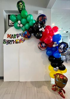 a bunch of balloons that are in the shape of avengers's head and shield