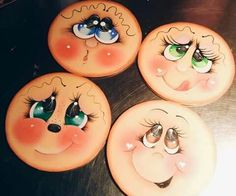 four donuts with faces painted on them