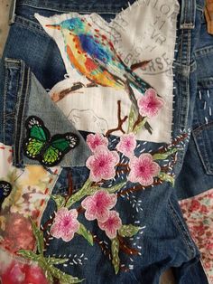 the back pocket of a pair of jeans with flowers and butterflies on them