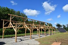 a wooden structure sitting on top of a lush green field