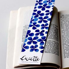 an open book with a blue and white tie on it's cover that says lacette