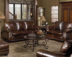 a living room with brown leather furniture and decor on the walls is featured in this ad