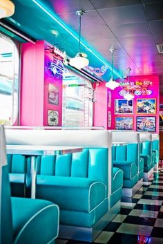 the interior of a diner with blue and pink booths