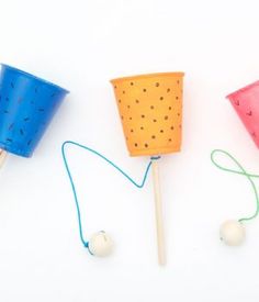 three different types of toothpicks with string attached to them on a white surface