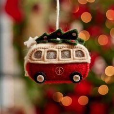 a red ornament hanging from a christmas tree