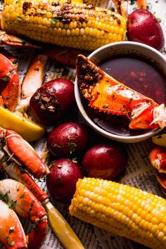 lobsters, corn on the cob and potatoes with dipping sauce