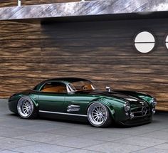 a green and black car parked in front of a building