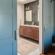 an open door leading to a bathroom with blue doors