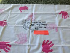 a piece of paper with pink handprints on it