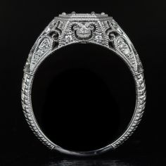 an antique style diamond engagement ring with filigrees