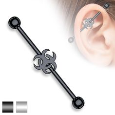 an ear piercing is shown with a black metal flower and cross design on the end