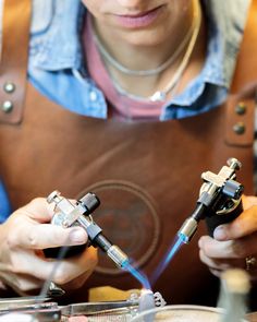 a woman in an apron is working on something