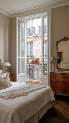 a bed sitting next to a window in a bedroom