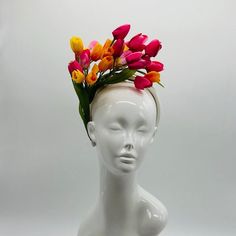 Handmade by Featured Milliner of The Kentucky Derby Museum 2023 & 2024! Spring has sprung! This is the perfect spring piece! Beautiful dark pink, yellow and light pink tulips with pops of green. Can be worn on either side! Attaches with headband.  Not taking customs this year--Derby 150 is going to be massive and mom life keeps me running! However, happy to suggest pieces that will coordinate with your outfit. If you don't love the way this attaches to your head--message me!  I can swtich *most* pieces to your preference. Clip, Headband OR Elastic Cord  NOTE: Heavier pieces with extravagant florals etc require the stability of a headband. NO RETURNS/EXCHANGES due to nature of product (special occasion and head wear). Not all screens/lighting are created equal. Make sure you are happy with Spring Multicolor Mini Hat With Curved Brim, Multicolor Spring Headband, Multicolor Headband For Spring, Spring Fascinator With Pinched Crown, Spring Pinched Crown Fascinator, Pink Spring Headpiece With Structured Crown, Spring Pink Headpiece With Structured Crown, Pink Structured Crown Headpiece For Spring, Pink Spring Fascinator With Structured Crown