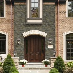 a large brick house with two front doors