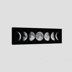 five phases of the moon are shown in this black and white photo, against a gray background