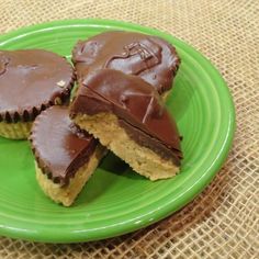 three chocolate peanut butter cups on a green plate