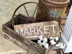 a wooden box filled with cotton sitting on top of a sidewalk