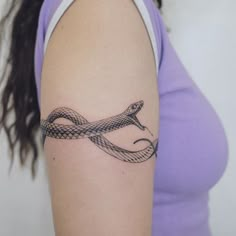 a woman with a snake tattoo on her arm