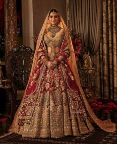 a woman in a red and gold bridal gown