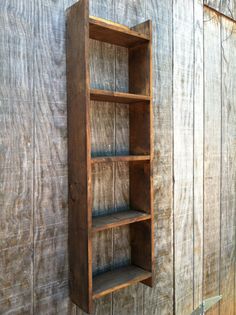 an old wooden shelf on the side of a building