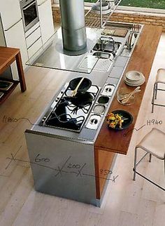 a kitchen with a stove top oven sitting next to a dining room table and chairs